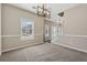 Open dining space features modern chandelier and flows into a living area at 2311 Fall Creek Lndg, Loganville, GA 30052