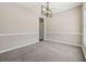 Neutral dining room featuring a modern chandelier and space for entertaining at 2311 Fall Creek Lndg, Loganville, GA 30052