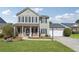 Charming two-story home with a well-manicured lawn, attached garage, and welcoming front porch at 2311 Fall Creek Lndg, Loganville, GA 30052