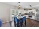 Charming kitchen features stainless steel appliances, white cabinets, and breakfast table at 2311 Fall Creek Lndg, Loganville, GA 30052
