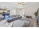 Spacious living room with cozy sectional, fireplace, and open floorplan to kitchen at 2311 Fall Creek Lndg, Loganville, GA 30052