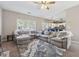 Bright, large living room featuring a comfortable sectional and views to the kitchen at 2311 Fall Creek Lndg, Loganville, GA 30052