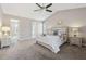 Spacious main bedroom with vaulted ceilings, carpet, and ensuite bathroom at 2311 Fall Creek Lndg, Loganville, GA 30052