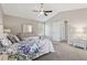 Bright and airy main bedroom with large windows, ensuite bathroom, and vaulted ceilings at 2311 Fall Creek Lndg, Loganville, GA 30052