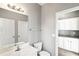 Bathroom view includes a toilet, mirror, towel rack, and white cabinets with granite countertops at 2740 Barimore Pl, Dacula, GA 30019