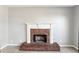 Close-up of a brick fireplace with white mantle and brick hearth at 2740 Barimore Pl, Dacula, GA 30019