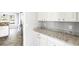 Bright kitchen featuring granite countertops, white cabinets, and stainless steel appliances at 2740 Barimore Pl, Dacula, GA 30019