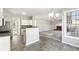Open kitchen with breakfast bar, stainless appliances, and view to living room fireplace at 2740 Barimore Pl, Dacula, GA 30019