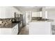 Charming kitchen features white cabinets, granite countertops, and stainless steel appliances at 2740 Barimore Pl, Dacula, GA 30019