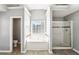 Main bathroom showcasing a soaking tub, large shower with glass door, and privacy window at 2740 Barimore Pl, Dacula, GA 30019