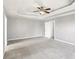 Spacious main bedroom with carpet flooring, a ceiling fan and multiple doors at 2740 Barimore Pl, Dacula, GA 30019