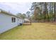 The home features a large grassy backyard and wooden deck at 6939 Hickory Log Rd, Austell, GA 30168