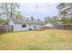 The home has a grassy backyard and small deck at 6939 Hickory Log Rd, Austell, GA 30168