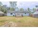 Grassy backyard featuring a small deck and fenced perimeter at 6939 Hickory Log Rd, Austell, GA 30168