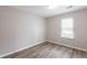 Bedroom with laminate flooring, a window offering natural light, and a neutral color palette at 6939 Hickory Log Rd, Austell, GA 30168