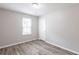 Bedroom featuring hard surface floors, neutral paint, natural light, and a closet at 6939 Hickory Log Rd, Austell, GA 30168