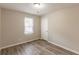 Bedroom features laminate flooring, a window with blinds, and a neutral color scheme at 6939 Hickory Log Rd, Austell, GA 30168