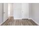 Bright bedroom features hard surface floors, neutral paint, and a door to an adjoining room at 6939 Hickory Log Rd, Austell, GA 30168