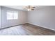 Bedroom featuring a ceiling fan, window, and laminate flooring at 6939 Hickory Log Rd, Austell, GA 30168