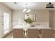 Bright dining room featuring elegant chandelier, white table and wainscotting along the wall at 6939 Hickory Log Rd, Austell, GA 30168