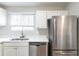 Updated kitchen features stainless steel appliances and bright white cabinetry at 6939 Hickory Log Rd, Austell, GA 30168