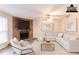 Staged living room boasts a cozy stone fireplace, stylish decor, and comfortable seating at 6939 Hickory Log Rd, Austell, GA 30168