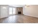Bright living room featuring a stone fireplace, large windows, and laminate floors at 6939 Hickory Log Rd, Austell, GA 30168
