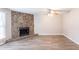 Spacious living room highlighting a stone fireplace, ceiling fan, and durable laminate floors at 6939 Hickory Log Rd, Austell, GA 30168