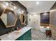 Stylish bathroom featuring double vanity, hexagon mirrors, standalone tub, and black and white tiled floors at 890 Memorial Se Dr # 101, Atlanta, GA 30316