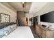 Spacious bedroom with concrete ceiling, wooden walls, and view of bathroom through glass doors at 890 Memorial Se Dr # 101, Atlanta, GA 30316