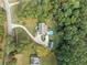 Aerial view of home with well-maintained landscaping, paved driveway, and in-ground pool at 2517 N Hightower Trl, Conyers, GA 30012