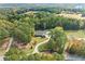Aerial view of a home with a large lawn and mature tree line at 2517 N Hightower Trl, Conyers, GA 30012