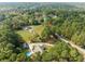 Home featuring a swimming pool and large acreage surrounded by a forest at 2517 N Hightower Trl, Conyers, GA 30012