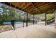 View of the back porch with an in-ground pool, detached garage, and fenced yard at 2517 N Hightower Trl, Conyers, GA 30012
