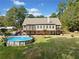 Large backyard featuring an above-ground pool, covered parking and an expansive lush green lawn at 2517 N Hightower Trl, Conyers, GA 30012