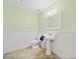 Bathroom with modern pedestal sink, toilet and wainscoting at 2517 N Hightower Trl, Conyers, GA 30012