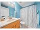 Bright bathroom with blue walls, marble vanity, and shower with modern fixtures at 2517 N Hightower Trl, Conyers, GA 30012