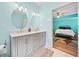 Bathroom with double vanity and access to a bedroom with accent colors at 2517 N Hightower Trl, Conyers, GA 30012