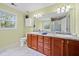 Bathroom vanity featuring dual sinks, bright lighting and tile floors at 2517 N Hightower Trl, Conyers, GA 30012