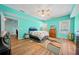 Bright bedroom features wood floors, ceiling fan, and an accent color at 2517 N Hightower Trl, Conyers, GA 30012
