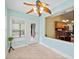 Sunny breakfast nook with views of the deck and kitchen features tile flooring and a ceiling fan at 2517 N Hightower Trl, Conyers, GA 30012