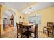 Dining room features tiled floors and view to the living room with brick fireplace at 2517 N Hightower Trl, Conyers, GA 30012