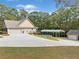 Long driveway to a multi-car garage with a covered parking area and a backyard pool at 2517 N Hightower Trl, Conyers, GA 30012
