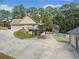 Expansive concrete driveway leading to a multi-car garage with a covered carport and a backyard pool at 2517 N Hightower Trl, Conyers, GA 30012