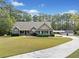 Well-maintained single-story home with attached garage, lush lawn, and mature trees at 2517 N Hightower Trl, Conyers, GA 30012