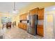 Open concept kitchen with stainless steel fridge and wood cabinets at 2517 N Hightower Trl, Conyers, GA 30012