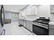 An open kitchen layout features stainless steel appliances and gray cabinets at 2517 N Hightower Trl, Conyers, GA 30012