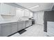 Modern kitchen boasts stainless steel appliances, gray cabinets, and bright countertops at 2517 N Hightower Trl, Conyers, GA 30012
