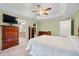 Bright primary bedroom with tray ceiling, ceiling fan and view to bath at 2517 N Hightower Trl, Conyers, GA 30012