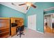 Office features built-in shelves, blue walls, neutral carpet, and a ceiling fan at 2517 N Hightower Trl, Conyers, GA 30012